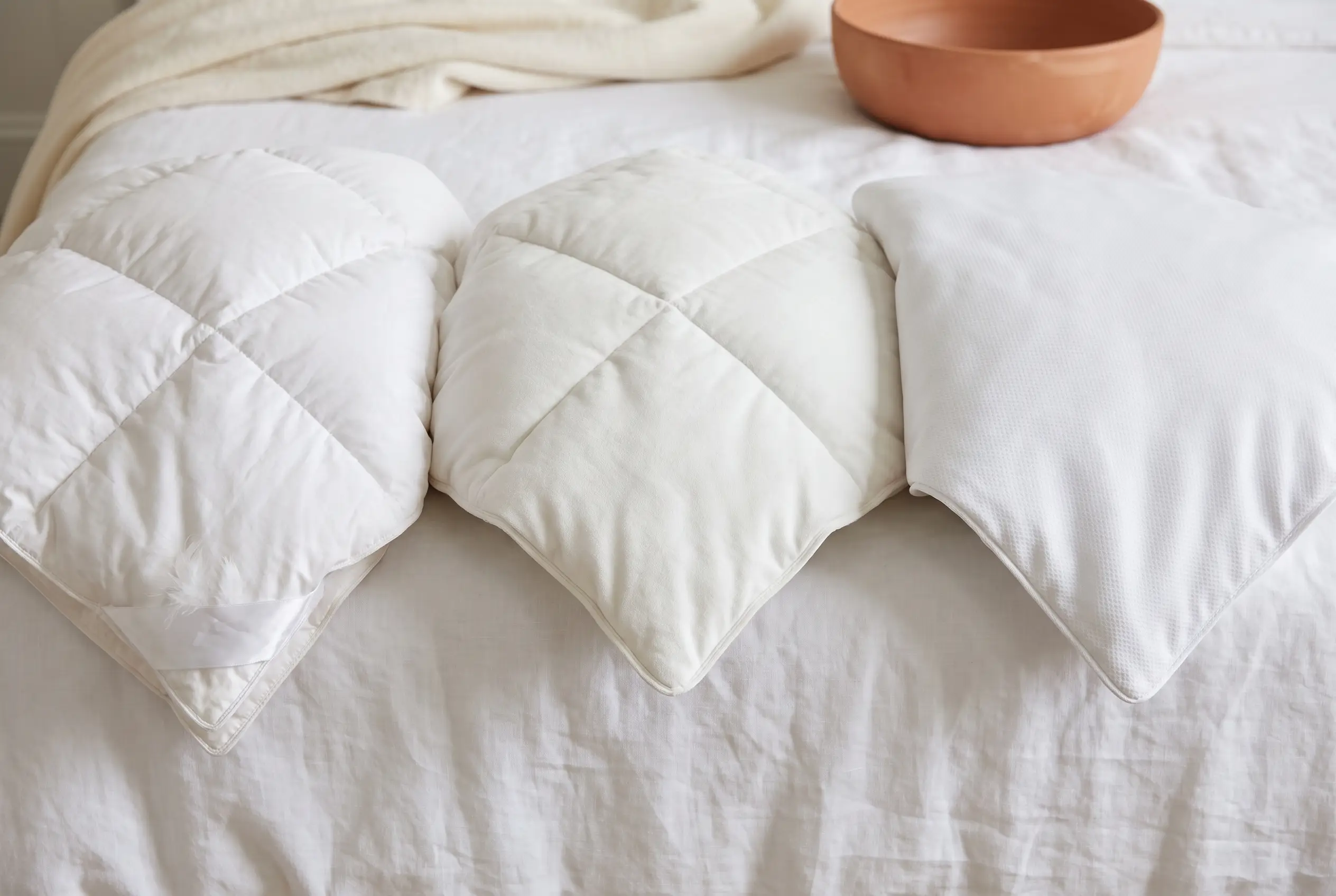 Down, down-alternative and cooling-weave comforter corners compared side by side