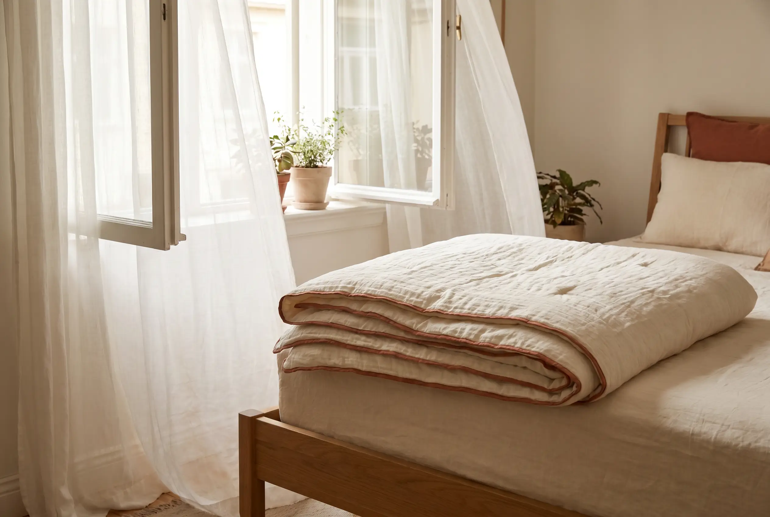 A light summer comforter with a breezy weave by an open window